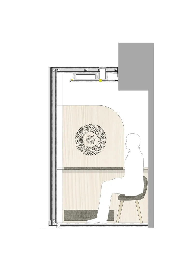 Section drawing showing seated figure inside confessional chamber with decorative motif and overhead lighting detail