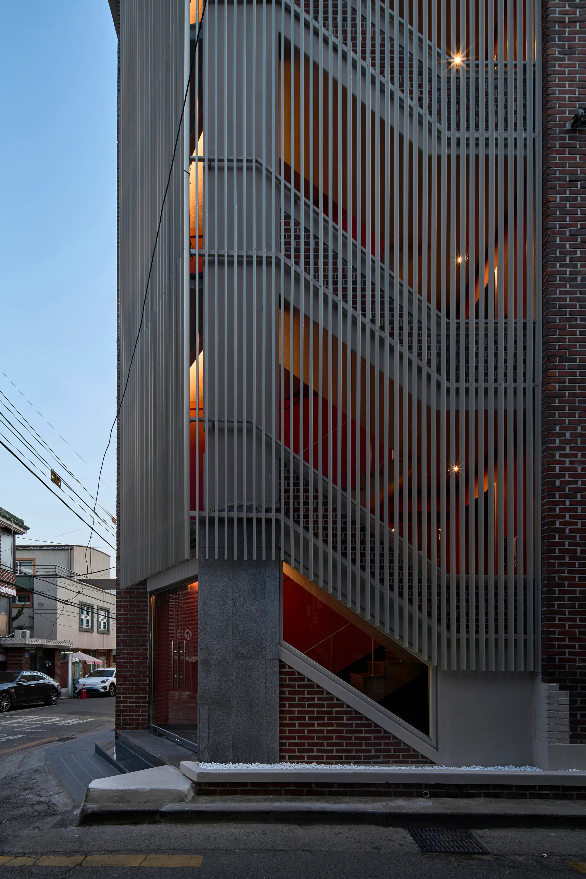 skimA Slots a Vertical Metal Tower into a Yeonnam-dong Brick House to Make It Mixed Use