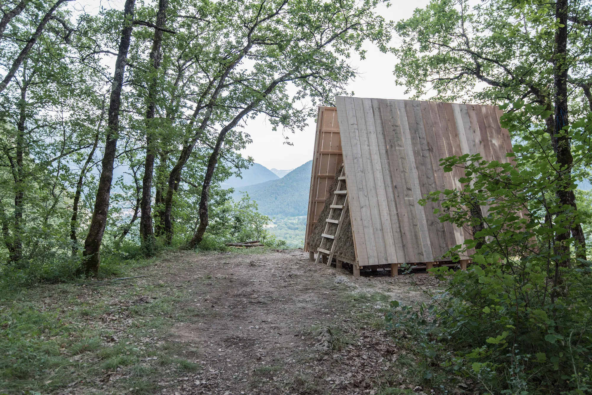 Still at Work Plants a Hay-Walled A-Frame Pavilion on a French Cliff for Cows and Humans Alike
