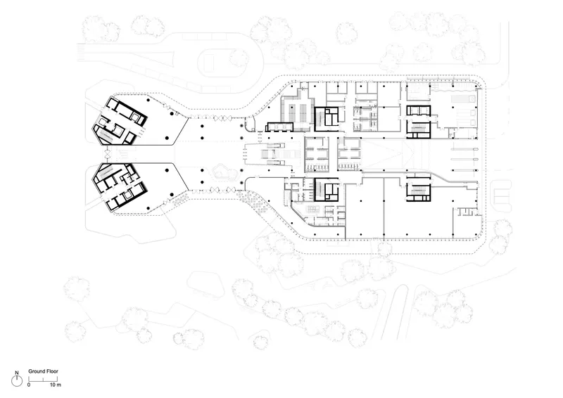 Ground floor plan drawing showing two offset wings with central cores and surrounding landscape