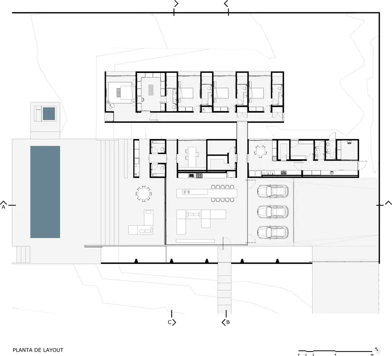 Floor plan drawing showing residential units, living spaces, garage with three cars, and pool
