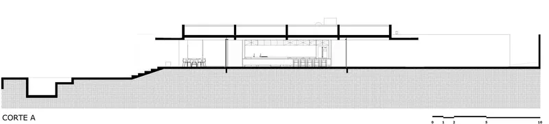 Section drawing showing the sloped site and single-story structure on elevated terrain