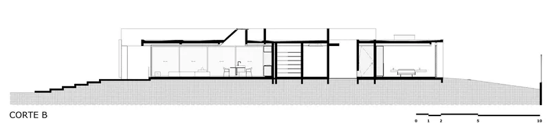 Section drawing showing the building stepping down the slope with multiple interior rooms