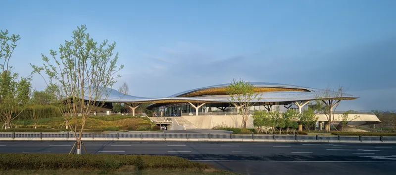 Street elevation showing the branching tree columns supporting the canopy roof with planted landscape