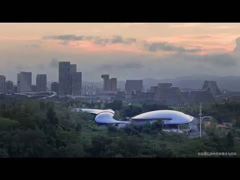 Distant view of the white cloverleaf roof nestled in greenery at dusk with city skyline beyond