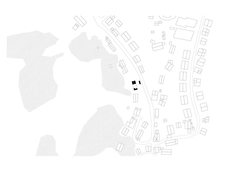 Site plan drawing showing a compact building cluster among diagonal streets and scattered neighboring structures