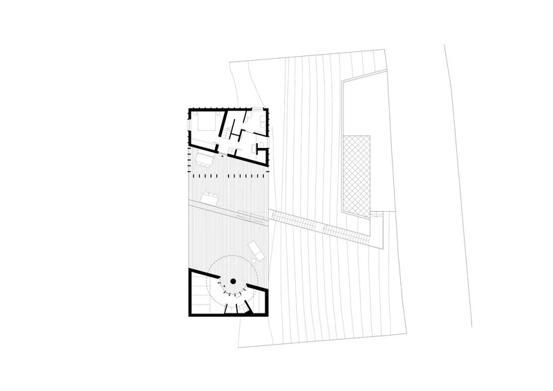 Ground floor plan drawing showing two angled volumes connected by a diagonal pathway and circular courtyard
