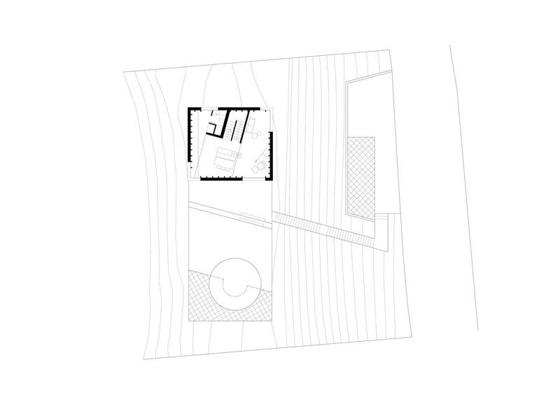 Upper floor plan drawing showing a rectangular volume elevated above a circular courtyard with radial paving