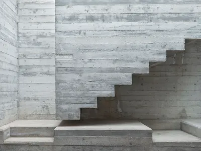MODEL Carves a Scarpa-Inspired Concrete Core Through a Maltese Period House for Two Sisters