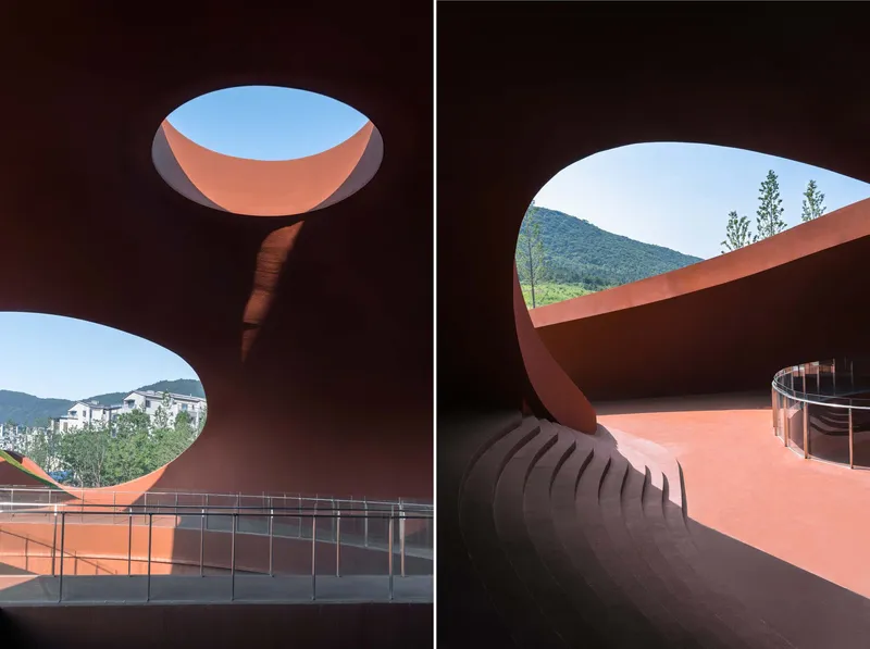 Interior views through elliptical and circular roof openings revealing mountain ridges and sky above terracotta surfaces