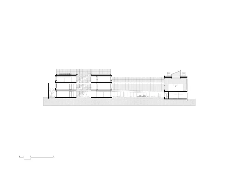 Section drawing showing two multi-story blocks connected by a gridded atrium courtyard
