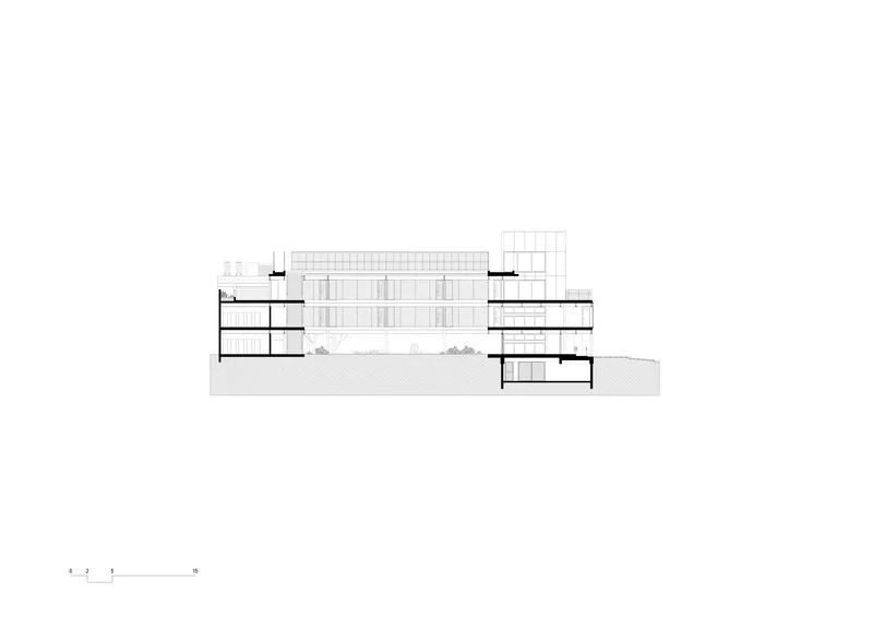 Section drawing showing flanking wings around a central glass-enclosed volume with visible floor plates