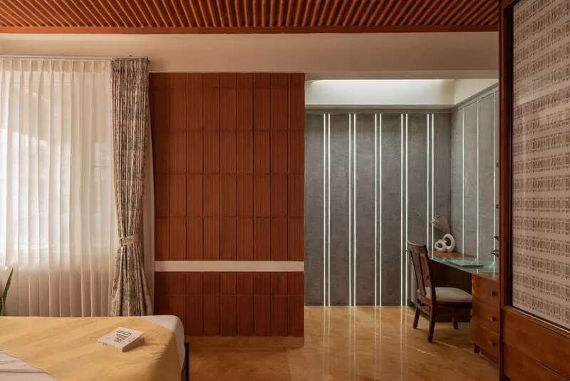 Bedroom workspace with timber cabinetry and vertically lit translucent wall panels under slatted timber ceiling
