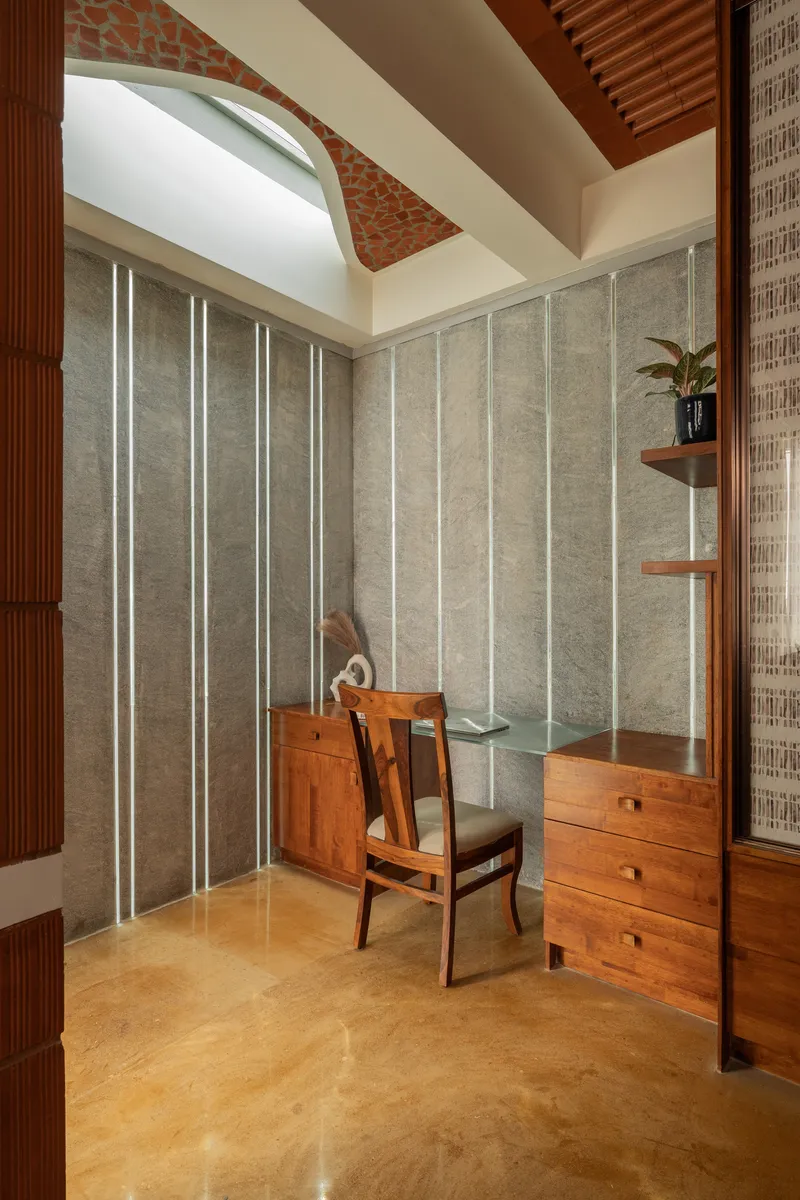 Study alcove showing decorative terracotta panel inset in curved ceiling soffit above workspace