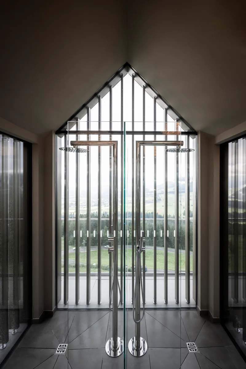 Interior entrance vestibule with vertical slat door and polished chrome handles on tiled floor