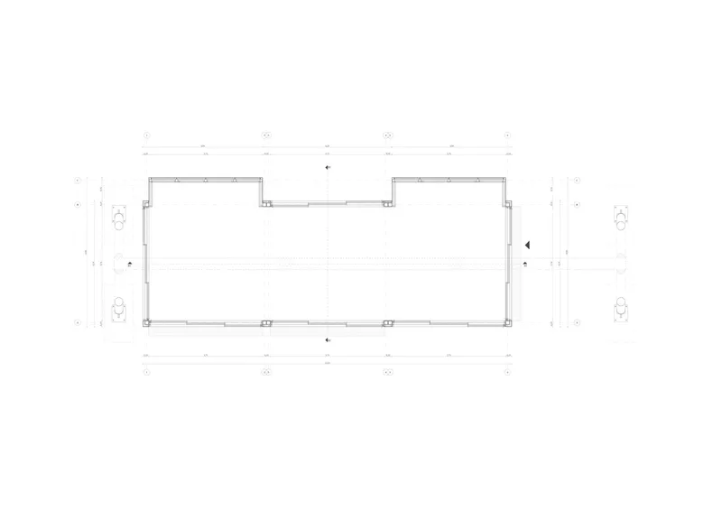 Floor plan drawing of a rectangular volume with dimension annotations and fixtures at the corners