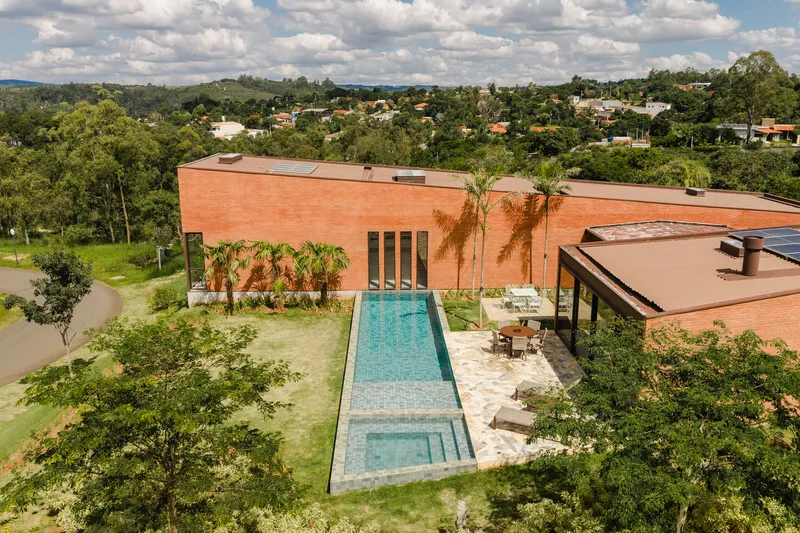 Elevated view of the lap pool and terrace with palm trees against the suburban neighborhood backdrop