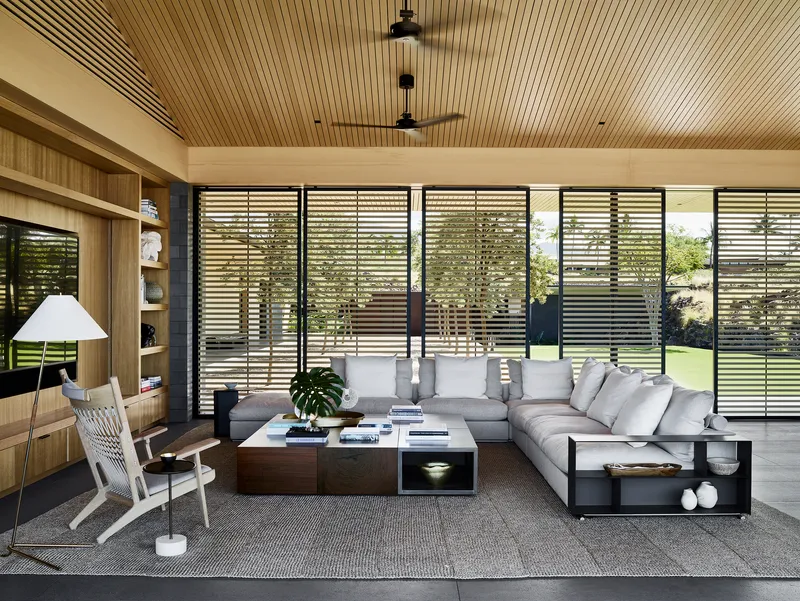 Living room with horizontal louvered screens and slatted timber ceiling under daylight