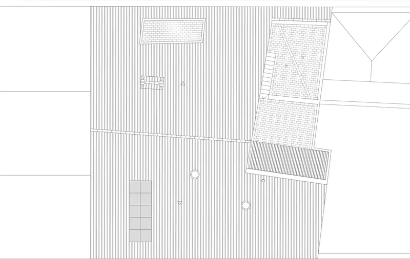 Site plan drawing showing the building footprint with striped paving and adjacent structures
