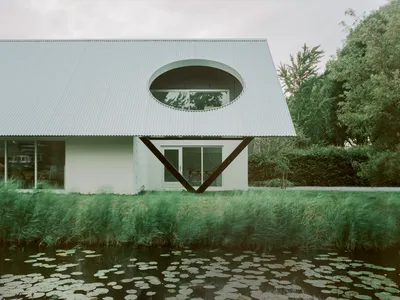 Space Encounters Crowns a 1980s Dutch House with Corrugated Aluminum and Geometric Apertures