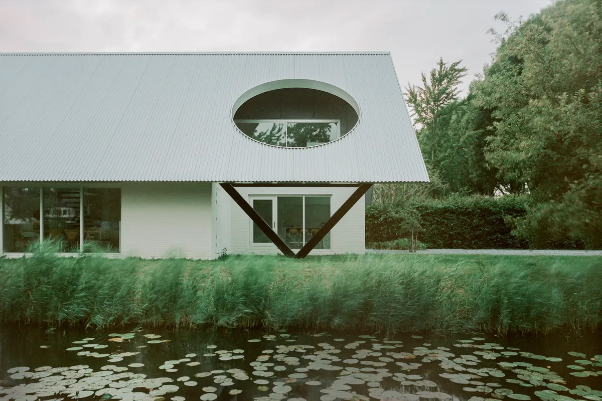 Space Encounters Crowns a 1980s Dutch House with Corrugated Aluminum and Geometric Apertures