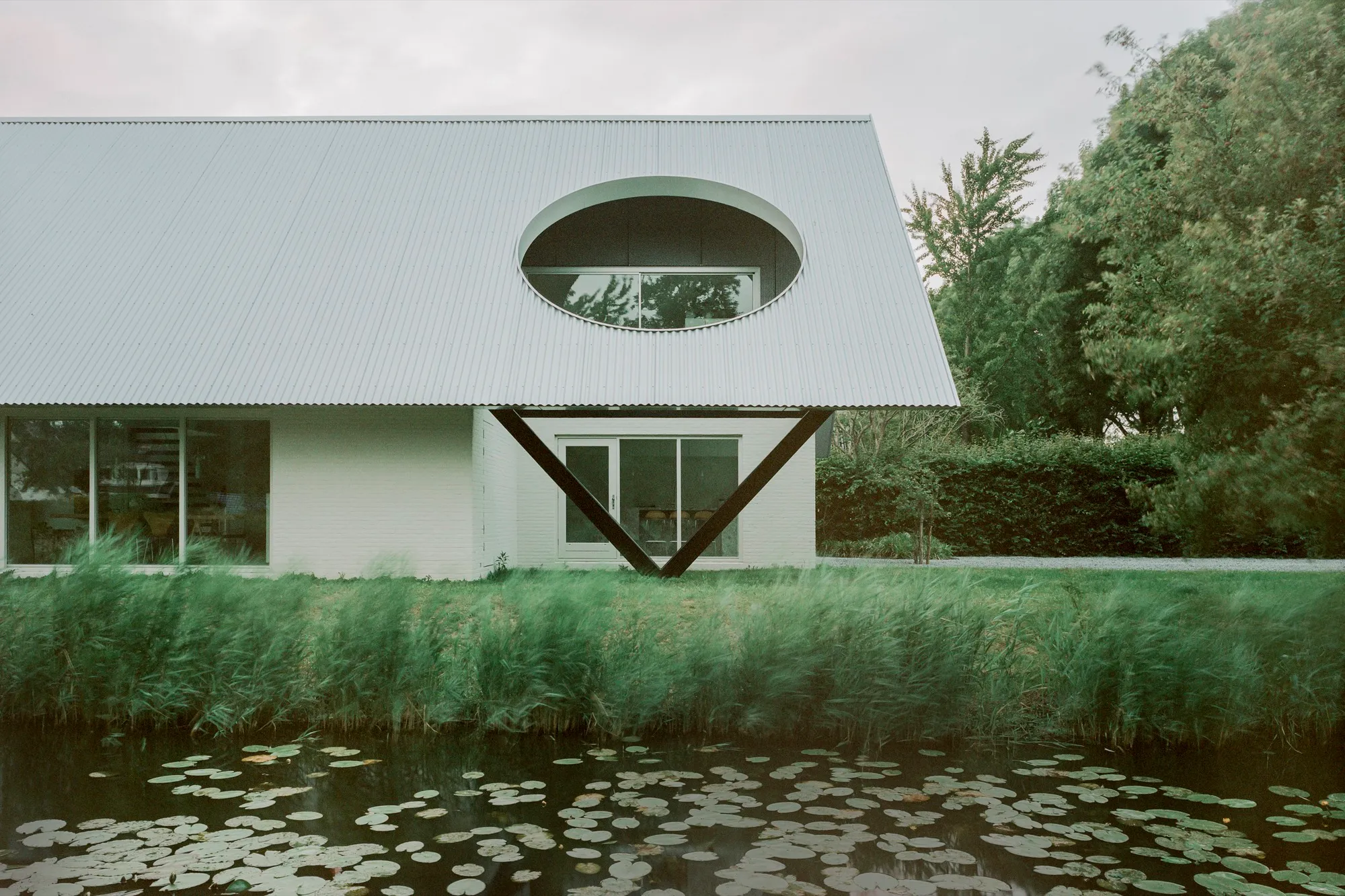 Space Encounters Crowns a 1980s Dutch House with Corrugated Aluminum and Geometric Apertures