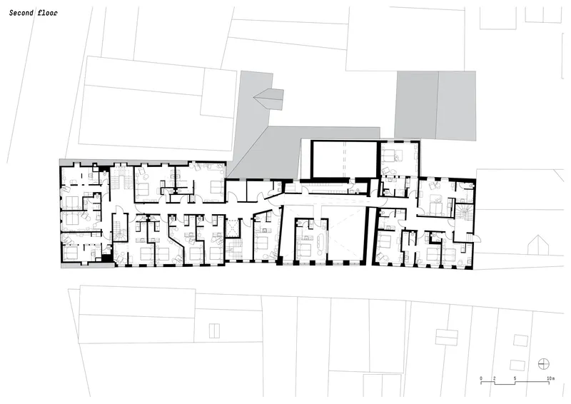 Second floor plan drawing showing residential units with adjacent rooftop terraces indicated in grey