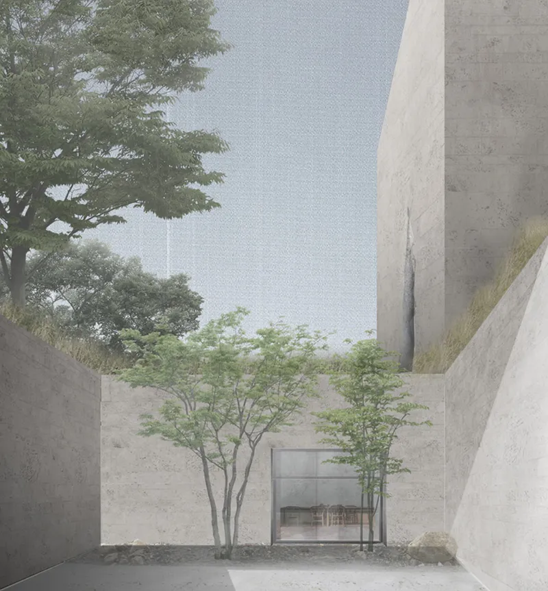 A quiet sunken courtyard connects stone walls, trees, and sacred space.
