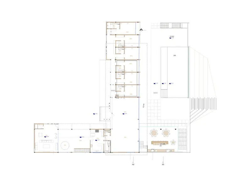 Floor plan drawing showing angled wings and terraced outdoor areas around a central courtyard
