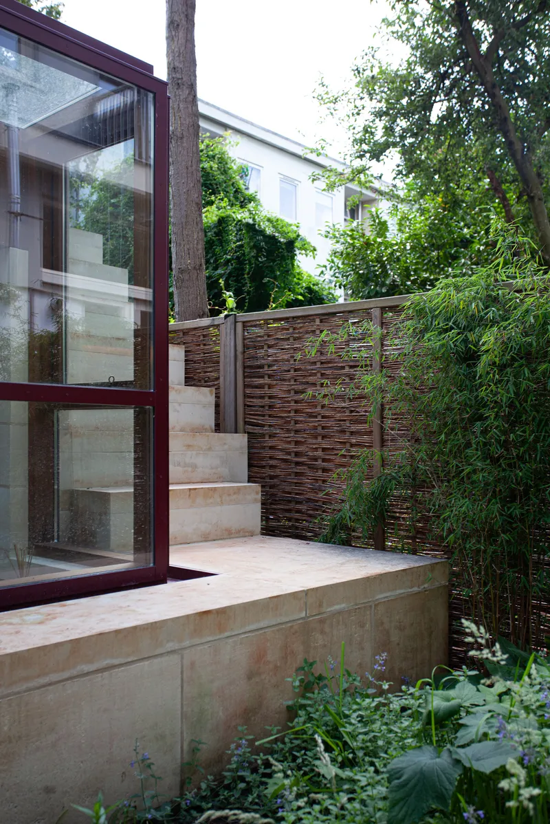 Garden terrace with limestone steps and timber screen fence surrounded by bamboo and tree canopy