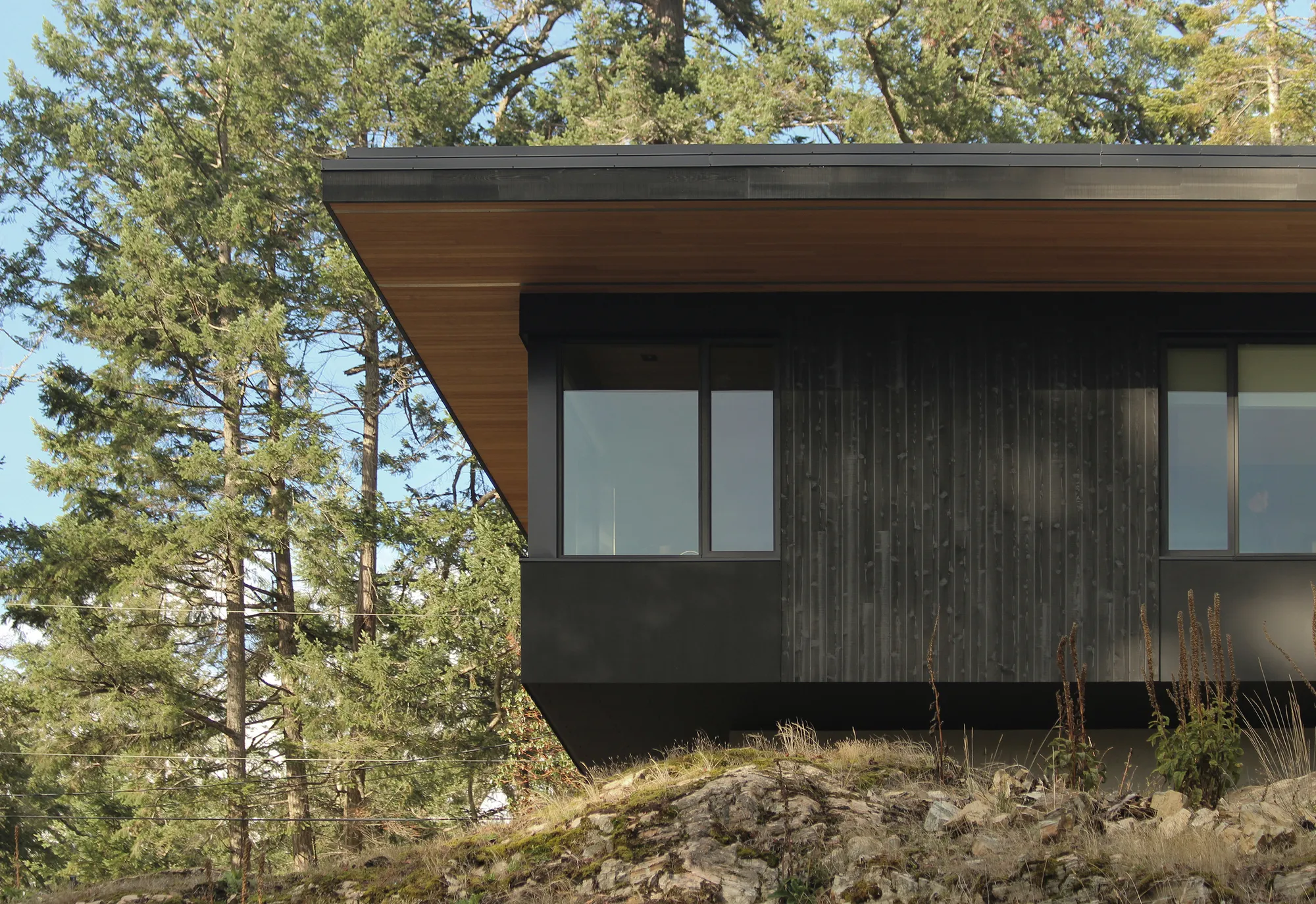 W O V E N Architecture Cantilevers a Charred Timber Retreat Over Salt Spring Island's Rocky Shore