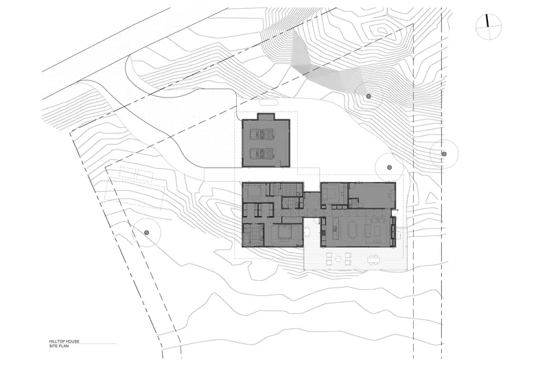 Site plan drawing showing building footprint on sloped topography with contour lines