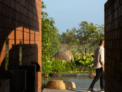 Studio Mango Sculpts Four Laterite Walls into a Lakeside Pavilion South of Chennai
