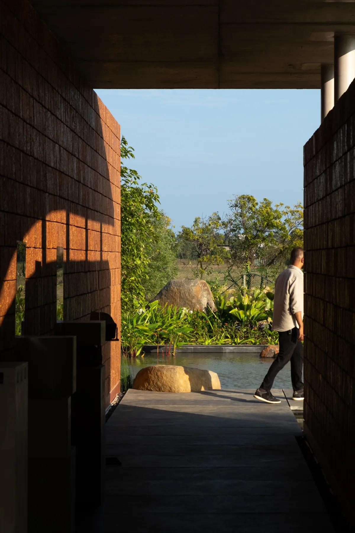Studio Mango Sculpts Four Laterite Walls into a Lakeside Pavilion South of Chennai