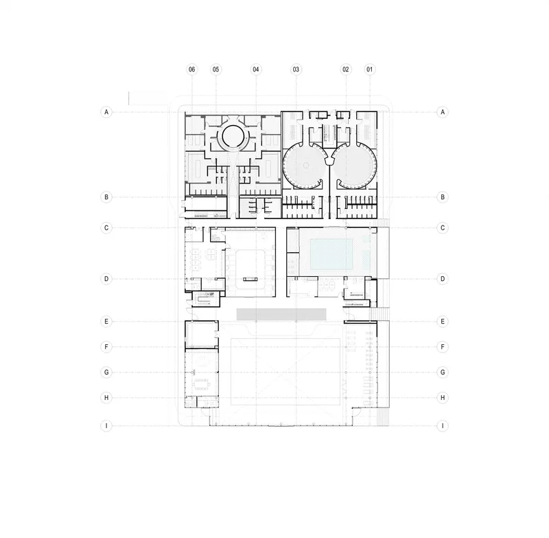 Floor plan showing two circular volumes on the upper portion and a large open field below