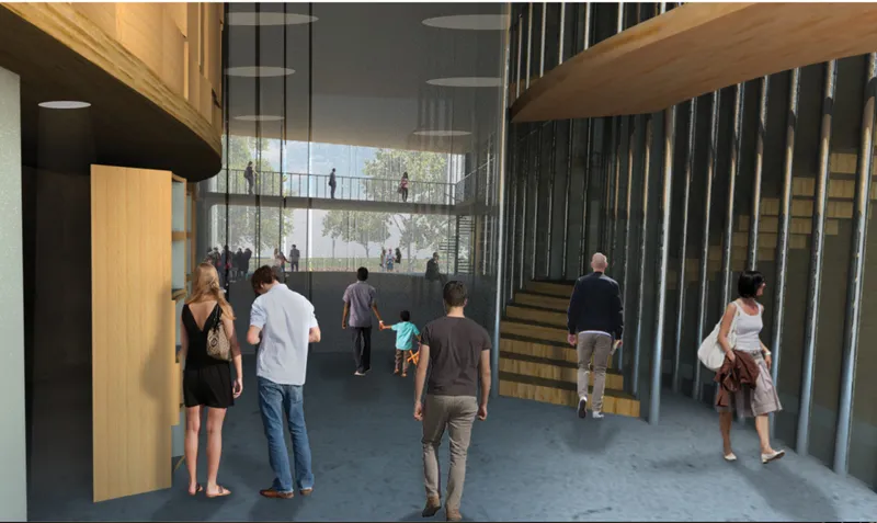 Ground floor entrance view with open circulation, timber details and visible public activity.