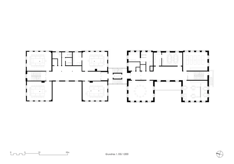 Ground floor plan showing two interconnected wings with multiple rooms and central circulation spaces