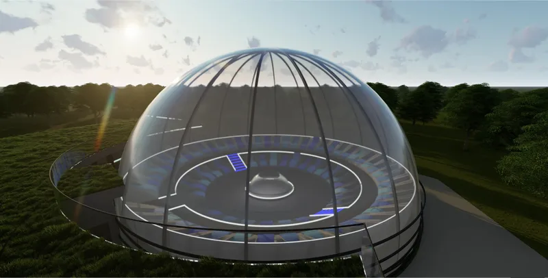 Elevated view of the glass-domed theater revealing its circular auditorium and integrated landscape setting.