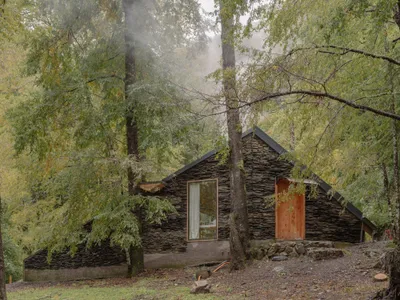DRAA Stacks Volcanic Stone into a Fire-Resistant Refuge that Disappears in the Chilean Forest