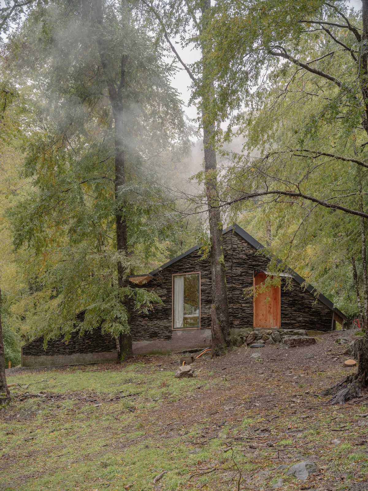 DRAA Stacks Volcanic Stone into a Fire-Resistant Refuge that Disappears in the Chilean Forest
