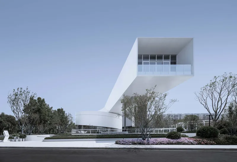 Side elevation showing the cantilevered upper volume with recessed glazing and planted landscape