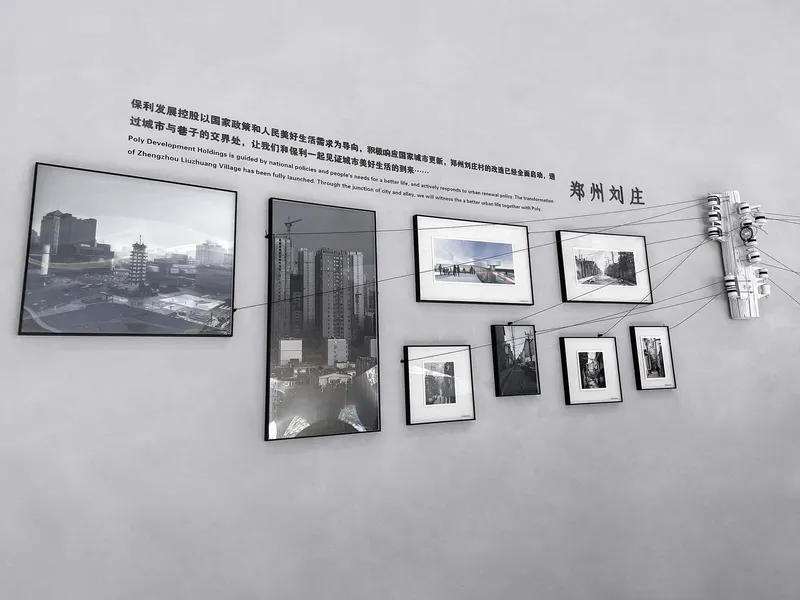 Gallery wall with framed photographs suspended on cables beneath a utility pole fragment