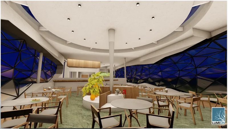 Night view of the main seating area, where sculptural ceiling forms and the geometric envelope create an immersive café atmosphere.