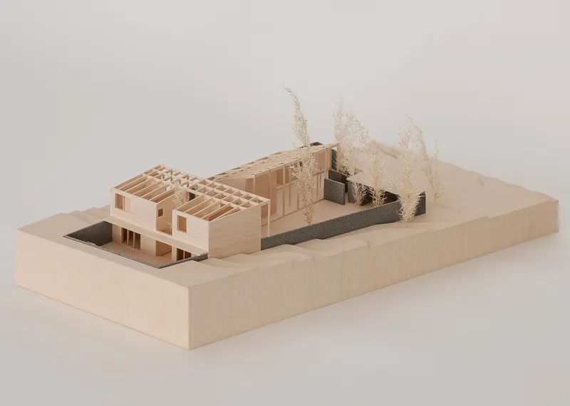 Physical model showing exposed timber framing and courtyard with miniature vegetation elements