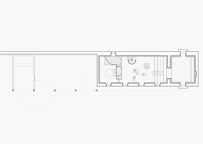 Floor plan drawing showing a linear layout with bathroom, bedroom, and circular courtyard element