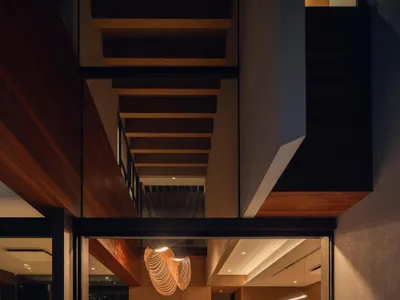 Ken Workshop Wraps a Jakarta Corner Lot in Timber and Stone to Guard Domestic Privacy