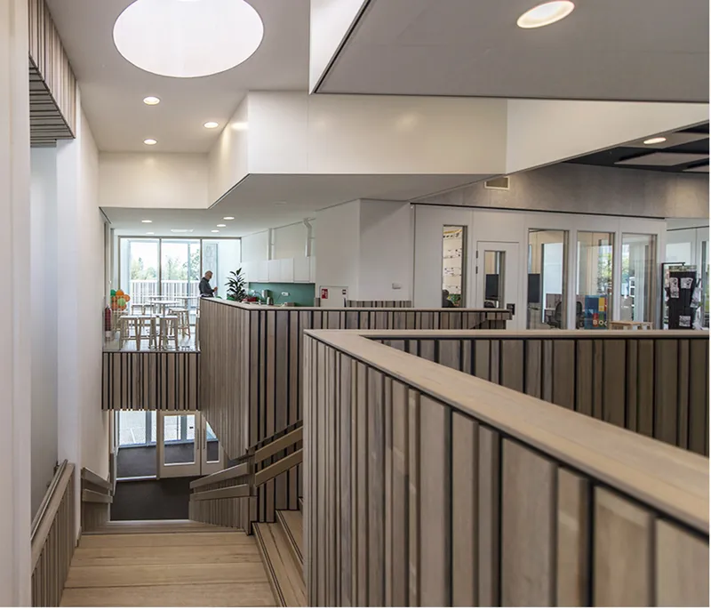 Warm interior circulation supports movement, gathering, and visual connection across levels.