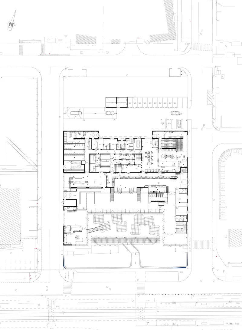 Floor plan drawing showing a rectangular building footprint with interior rooms and surrounding street context
