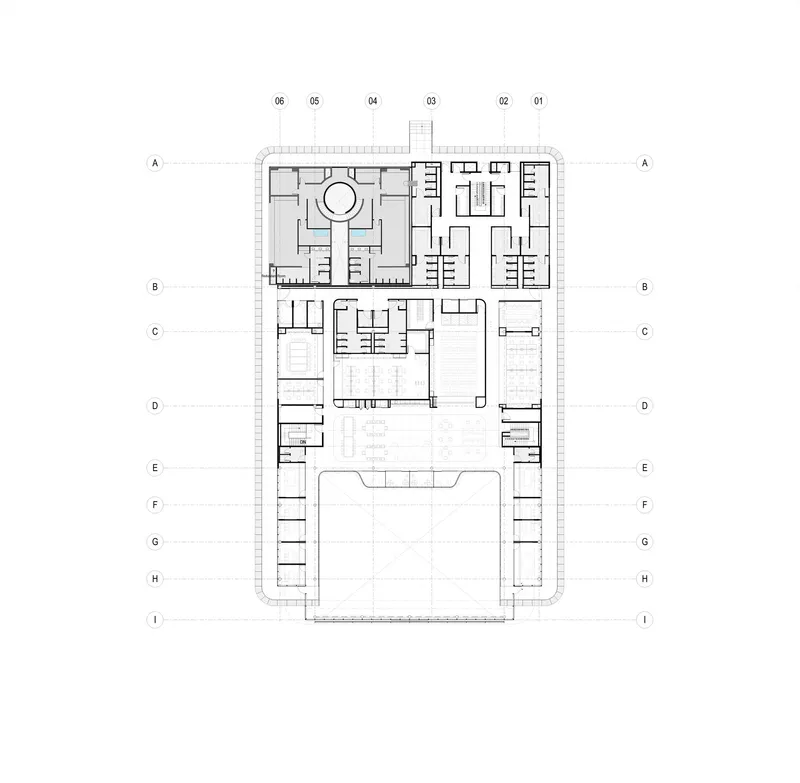 Floor plan drawing showing classrooms around circular courtyard with central pool and outdoor playing court below