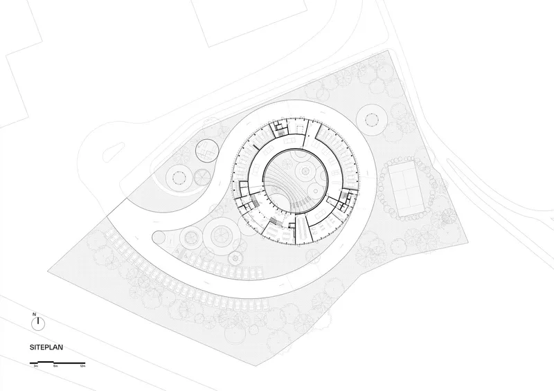 Site plan drawing showing a circular ring-shaped structure within landscaped grounds and adjacent contexts